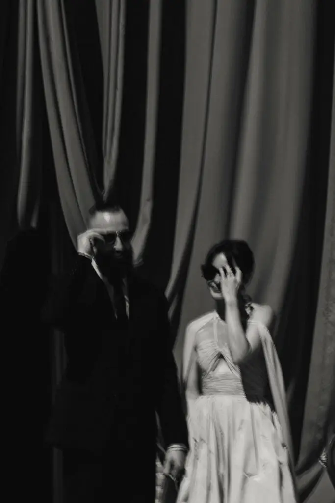 Lee and Damien laughing in black and white at their wedding at Château du Pujolet